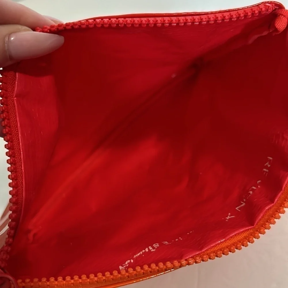 The Revlon x Megan Thee Stallion makeup bag with oversized zipper